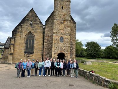 A group of people standing in front of St. Peters Church